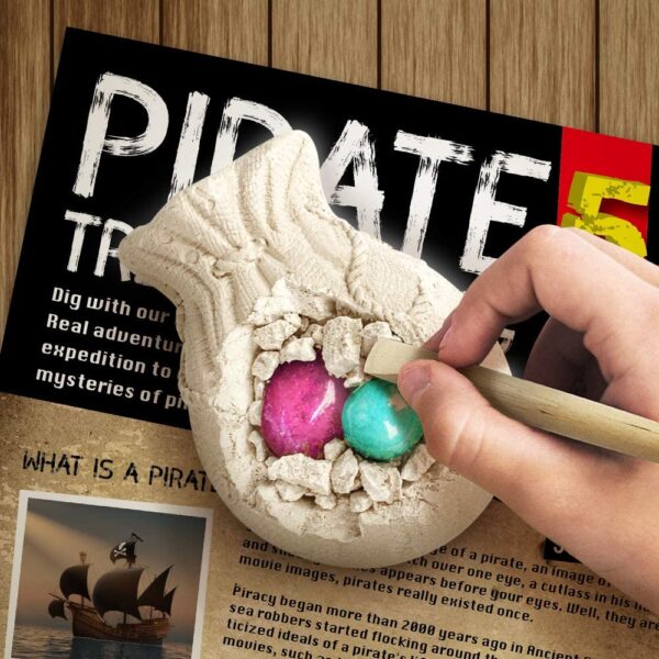 5 in 1 Pirate Treasure Dig Kit hands digging into a mound of clay 'earth' exposing the gem treasure