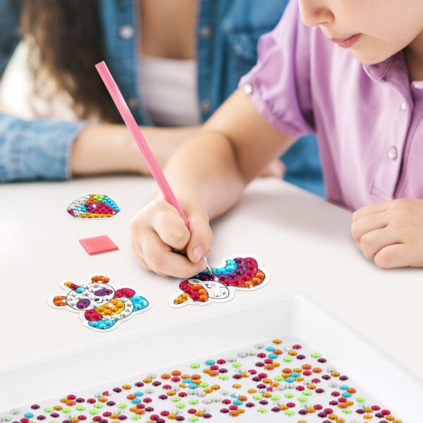 Girl using our Big Gems Diamond Painting Kit on a Unicorn Sticker Arts & Crafts Kit